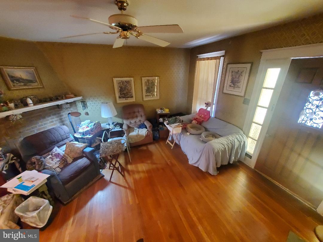 207 Avon Road Upper Darby, PA 19082 - Photo 2 of 29 a living room with furniture and a wooden floor