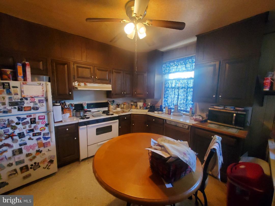 207 Avon Road Upper Darby, PA 19082 - Photo 4 of 29 a kitchen with stainless steel appliances granite countertop a sink a stove and a microwave