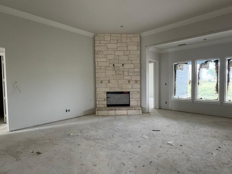 2305 Quartz Street Krum, TX 76249 - Photo 7 of 18 a view of an empty room with a fireplace and a window