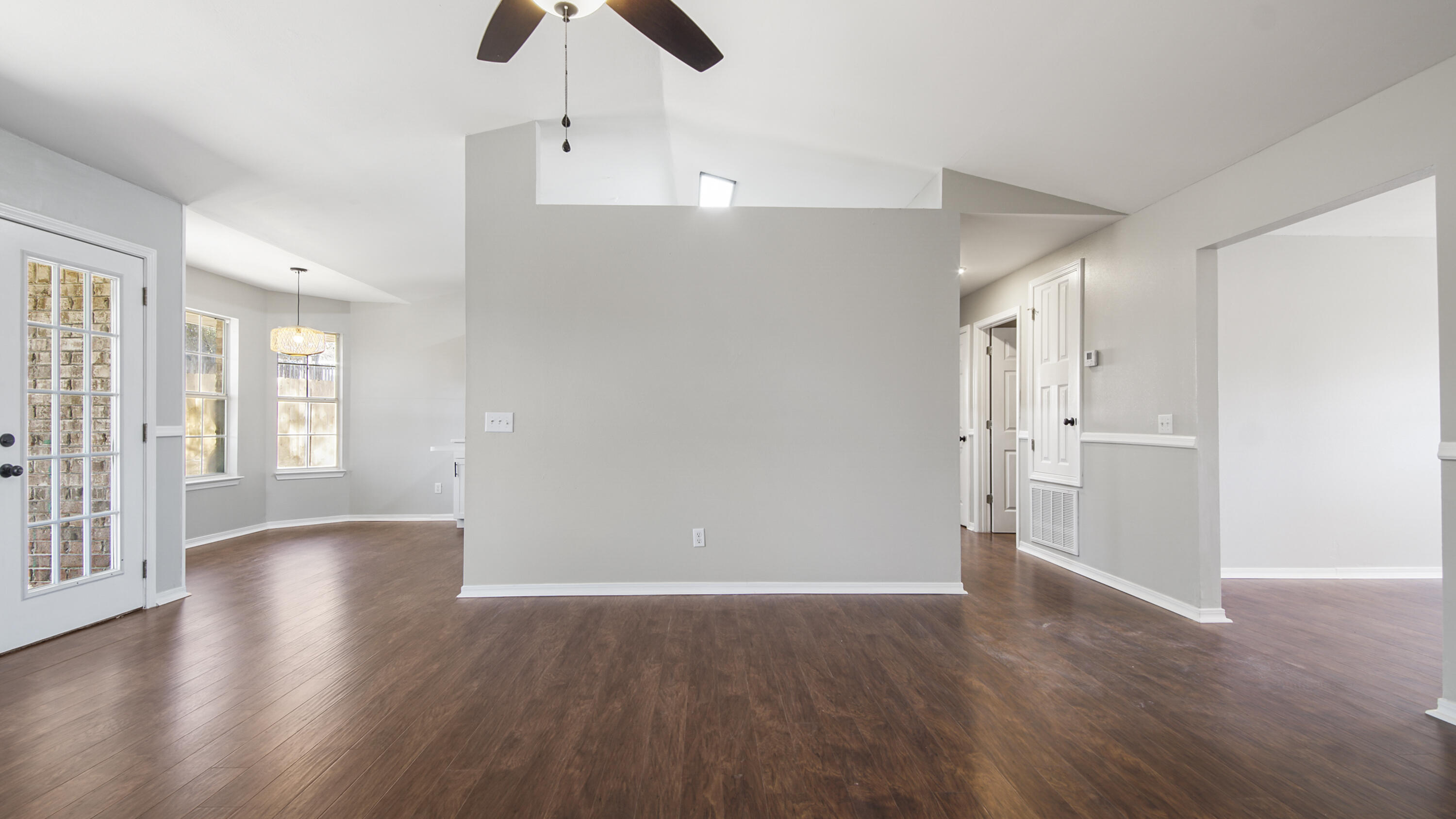 5200 Whitehurst Lane Crestview, FL 32536 - Photo 20 of 49 a view of an empty room with wooden floor and a window
