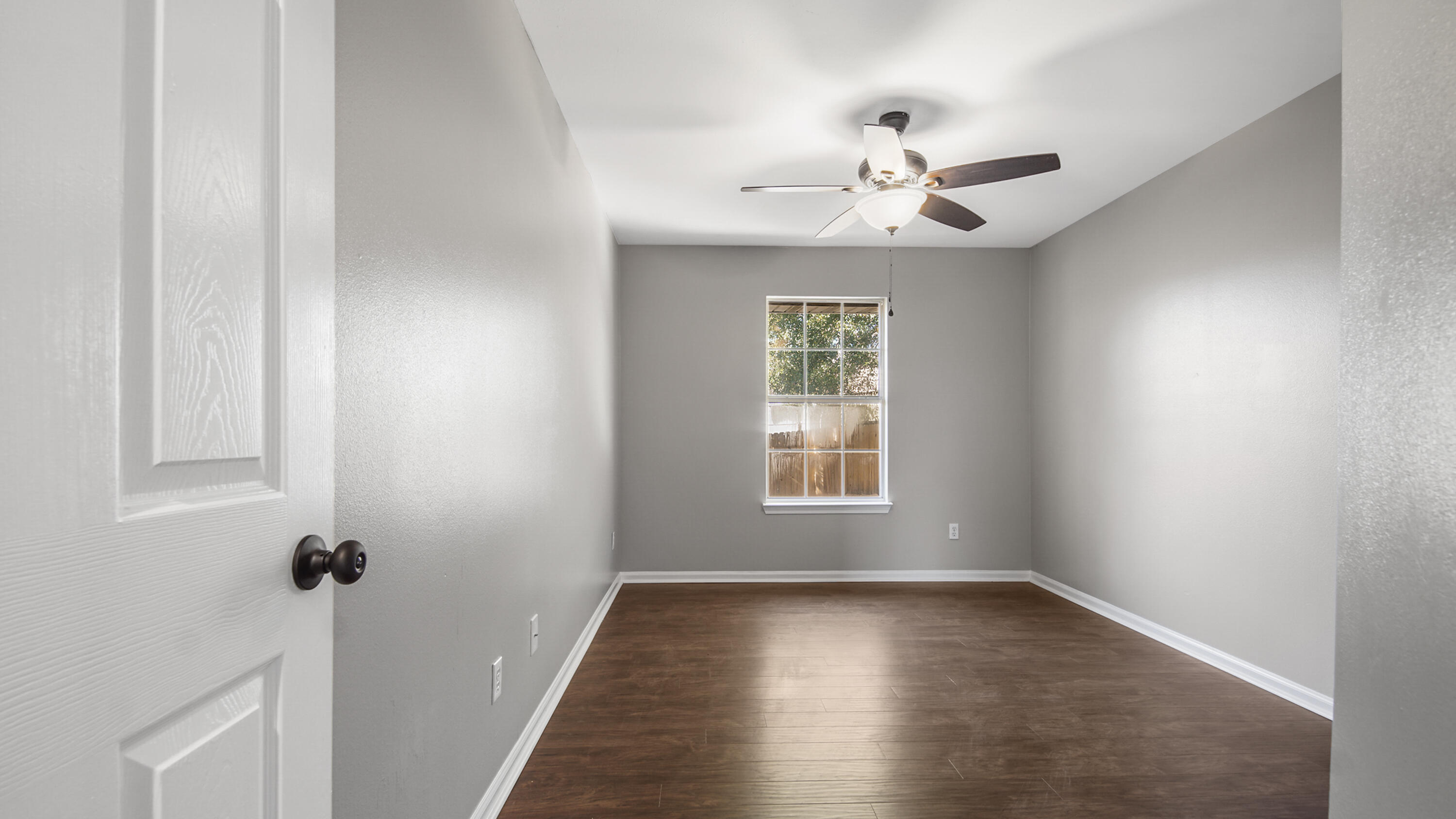 5200 Whitehurst Lane Crestview, FL 32536 - Photo 28 of 49 wooden floor in an empty room with a window
