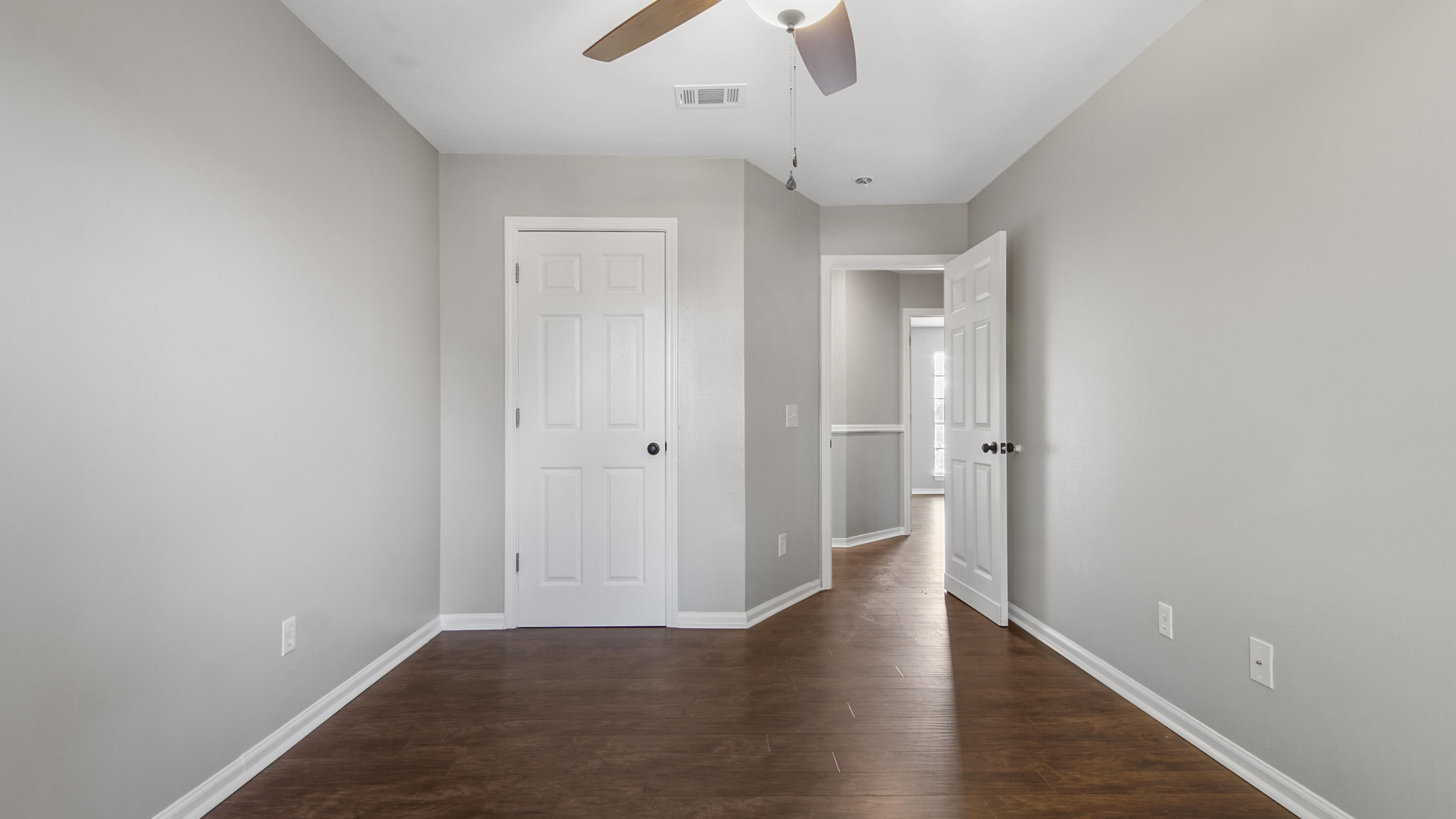 5200 Whitehurst Lane Crestview, FL 32536 - Photo 29 of 49 a view of a hallway with wooden floor