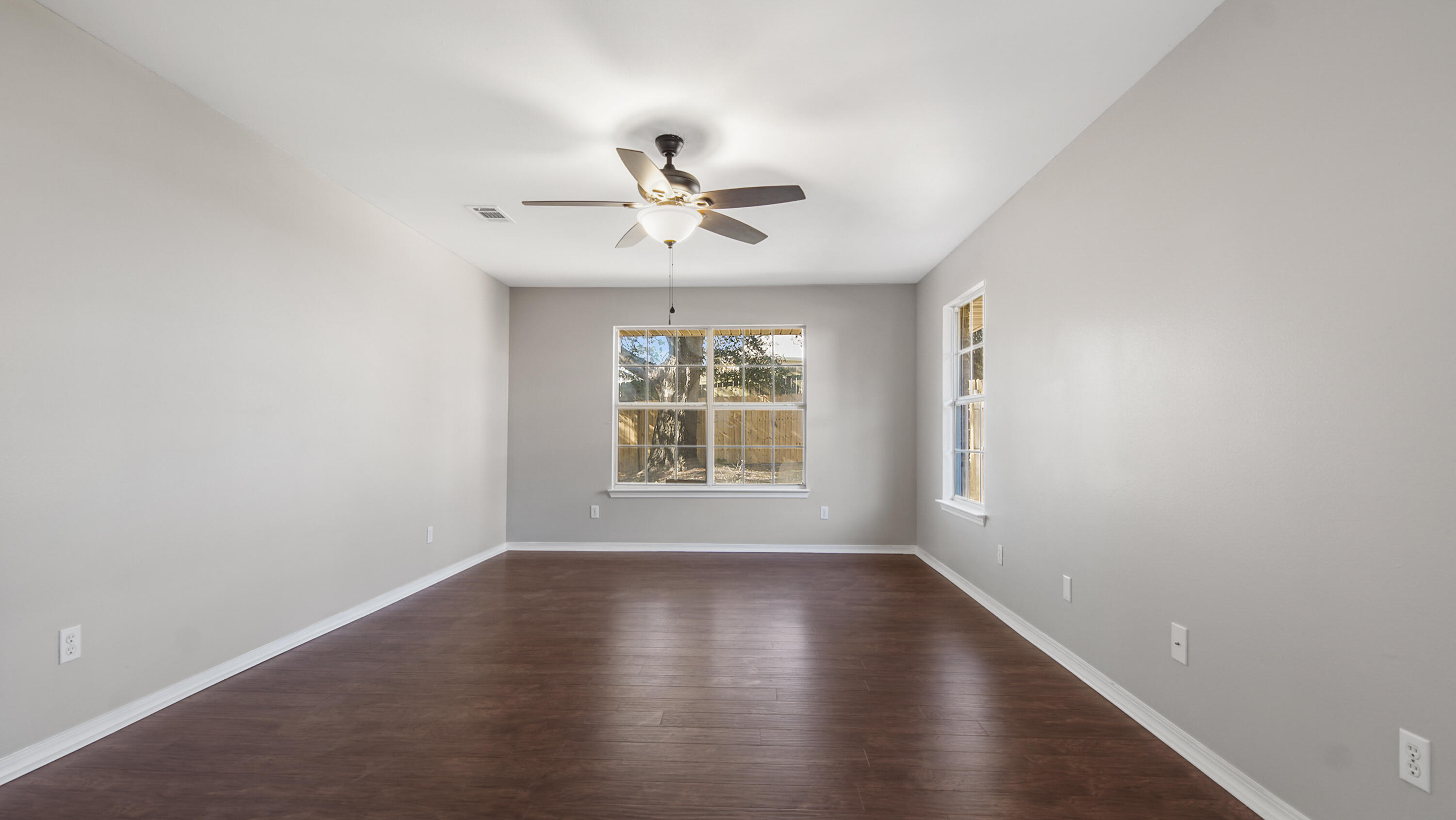 5200 Whitehurst Lane Crestview, FL 32536 - Photo 40 of 49 a view of an empty room with wooden floor and a window
