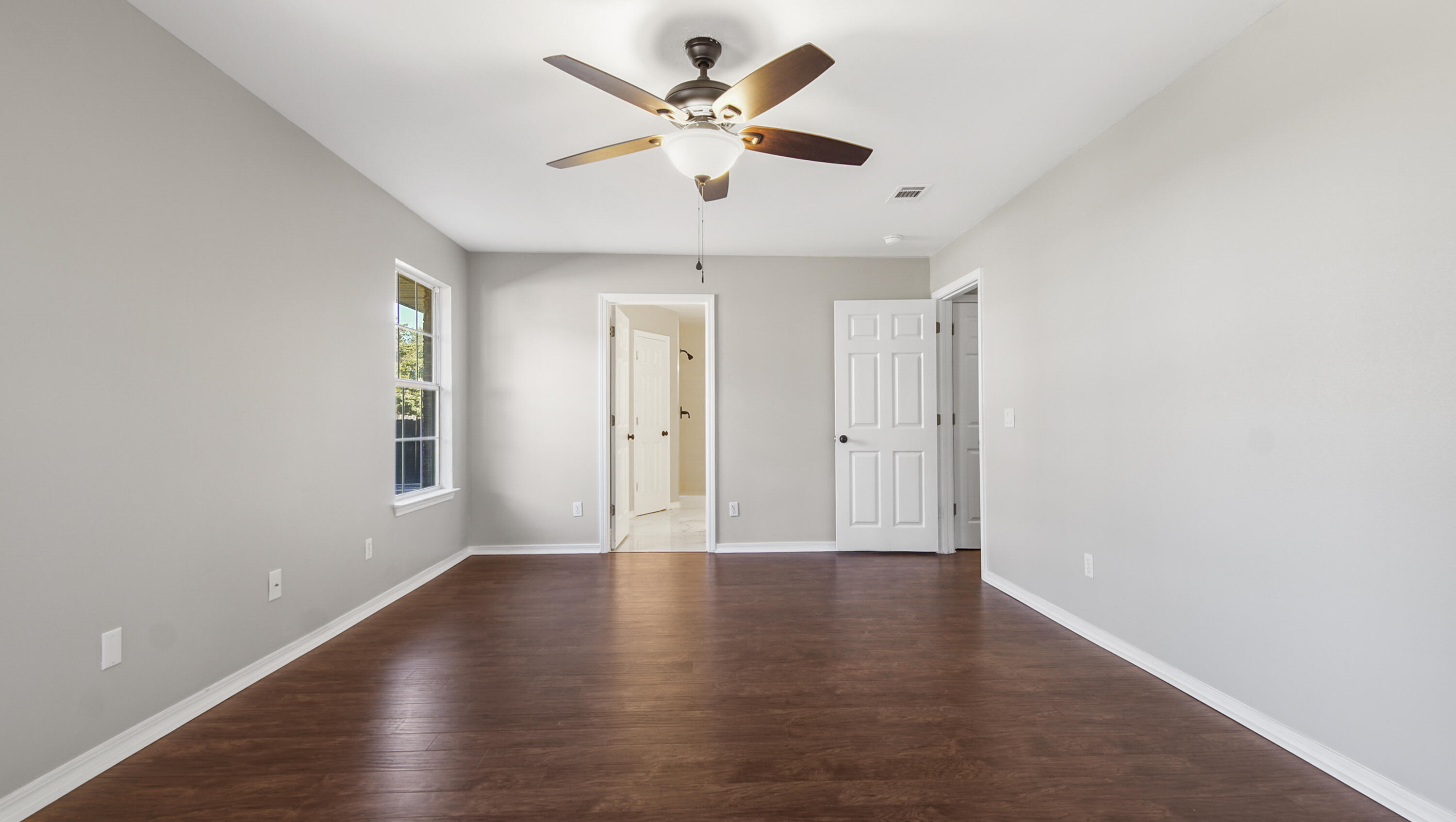 5200 Whitehurst Lane Crestview, FL 32536 - Photo 41 of 49 an empty room with wooden floor and ceiling fan