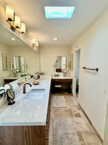 a view of a kitchen with a sink and living room