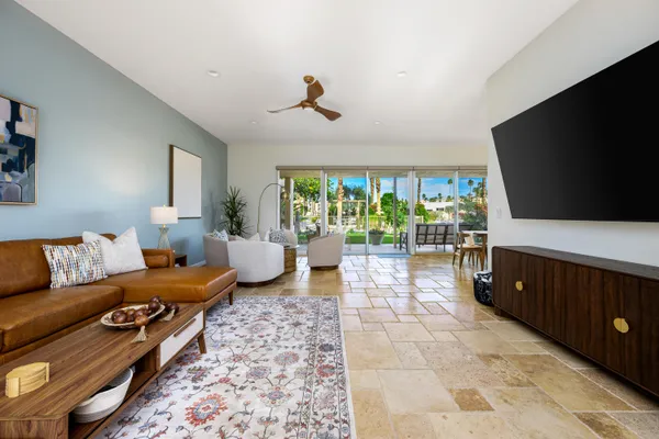 a bedroom with furniture and a flat screen tv