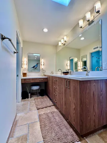a bathroom with a sink a vanity and a mirror