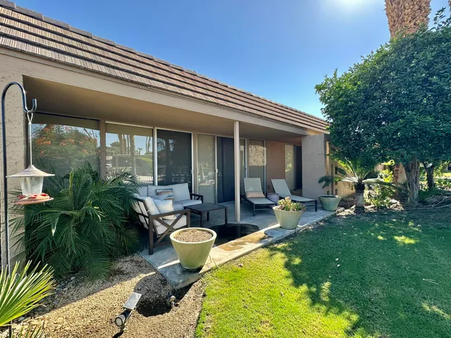a view of a house with backyard porch and sitting area