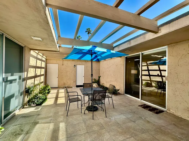 a view of a dining table and chairs in the patio