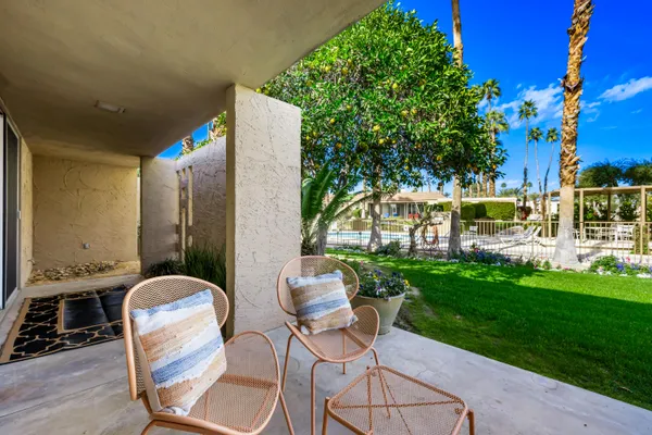 a view of a house with backyard and sitting area