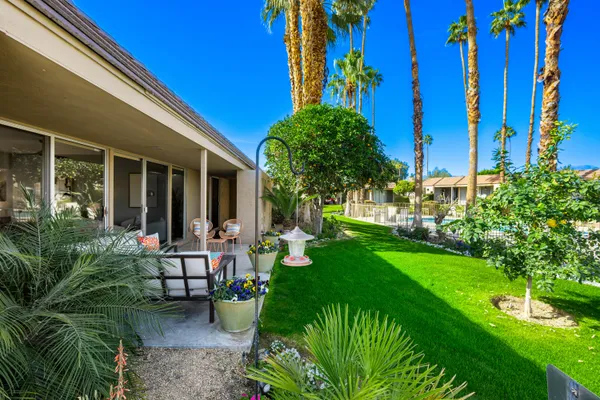 a view of a backyard with sitting area
