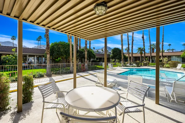a living room with furniture a flat screen tv and a window