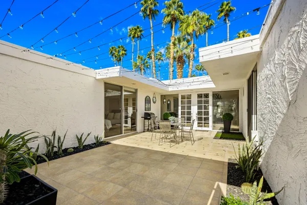 a view of a dining room with furniture window and outdoor kitchen