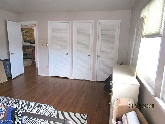 a view of an empty room and wooden floor