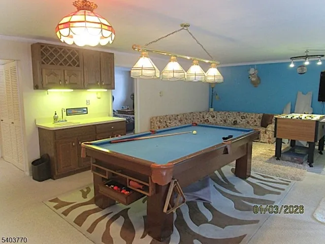 a room with pool table and windows