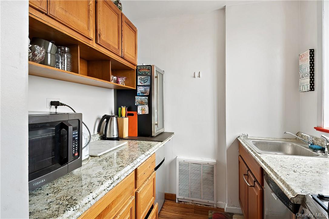 4320 Van Cortlandt Park East, Unit 6B Bronx, NY 10470 - Photo 11 of 19 a kitchen with stainless steel appliances granite countertop a sink stove and cabinets