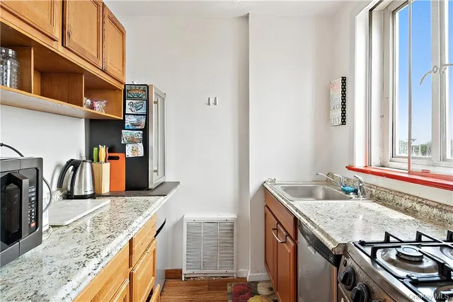 a kitchen with stainless steel appliances granite countertop a sink stove and refrigerator
