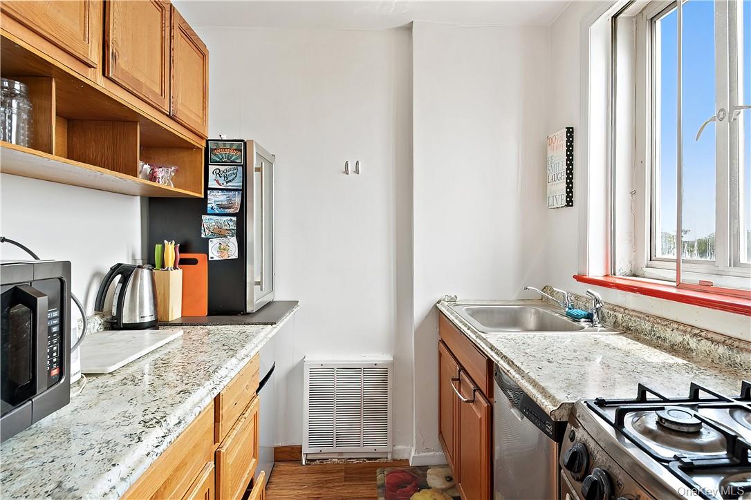 4320 Van Cortlandt Park East, Unit 6B Bronx, NY 10470 - Photo 10 of 19 a kitchen with stainless steel appliances granite countertop a sink stove and refrigerator