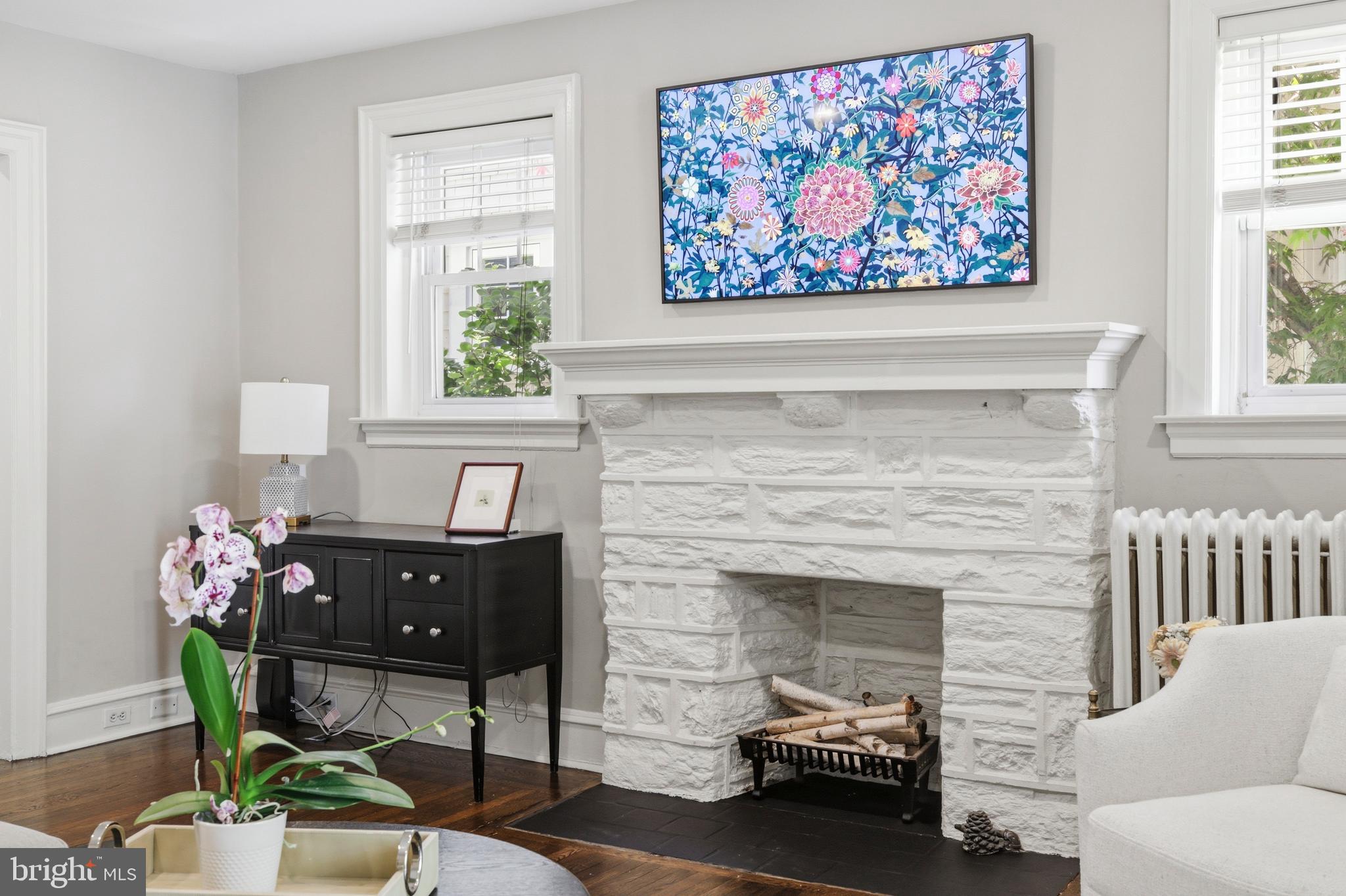 307 East Gravers Lane Philadelphia, PA 19118 - Photo 13 of 44 a living room with furniture flower pot and a fireplace