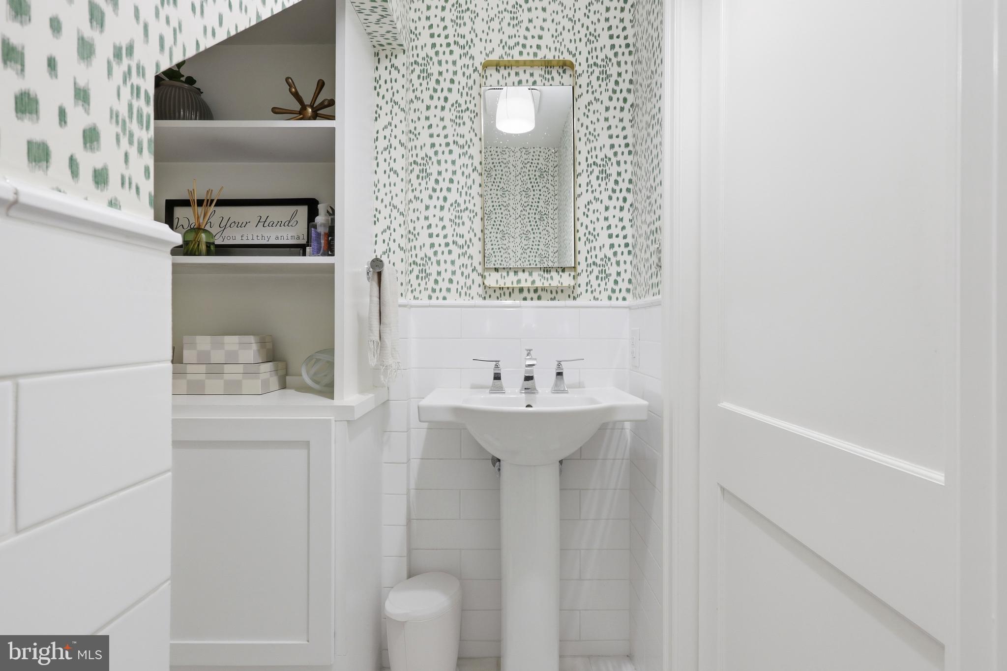 307 East Gravers Lane Philadelphia, PA 19118 - Photo 16 of 44 a bathroom with a sink a toilet and mirror