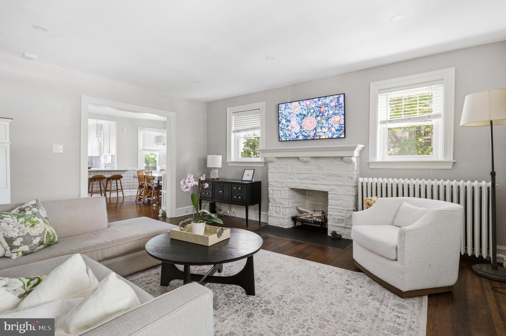 307 East Gravers Lane Philadelphia, PA 19118 - Photo 2 of 44 a living room with furniture a fireplace and a large window