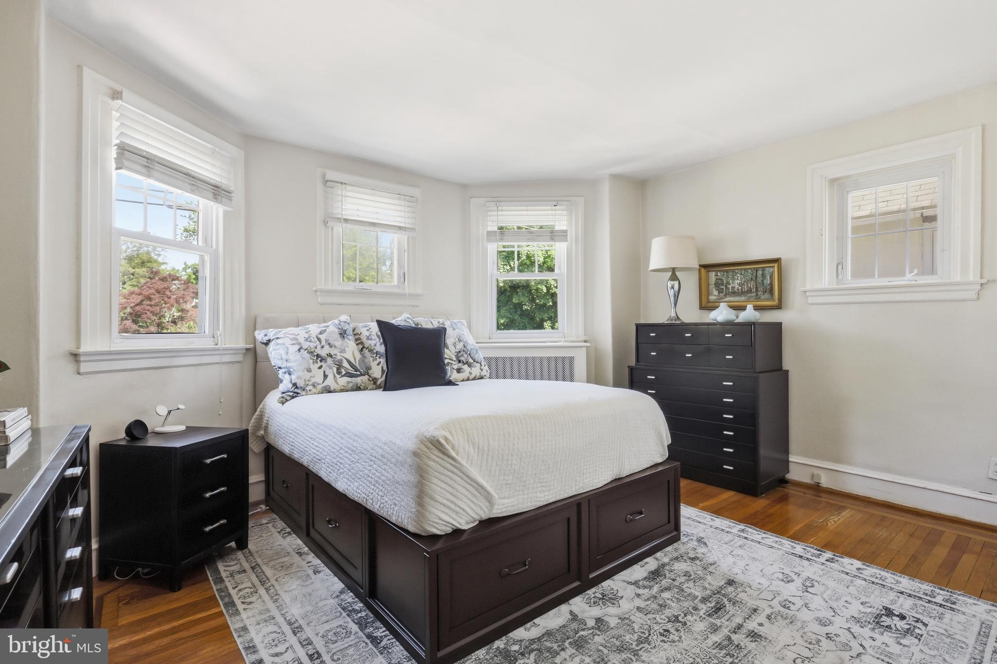 307 East Gravers Lane Philadelphia, PA 19118 - Photo 23 of 44 a large bedroom with a bed and wooden floor