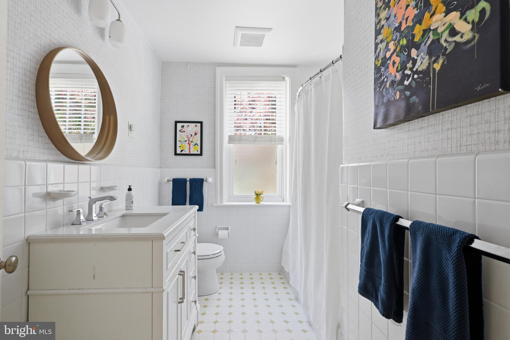 307 East Gravers Lane Philadelphia, PA 19118 - Photo 27 of 44 a bathroom with a sink a toilet and a mirror