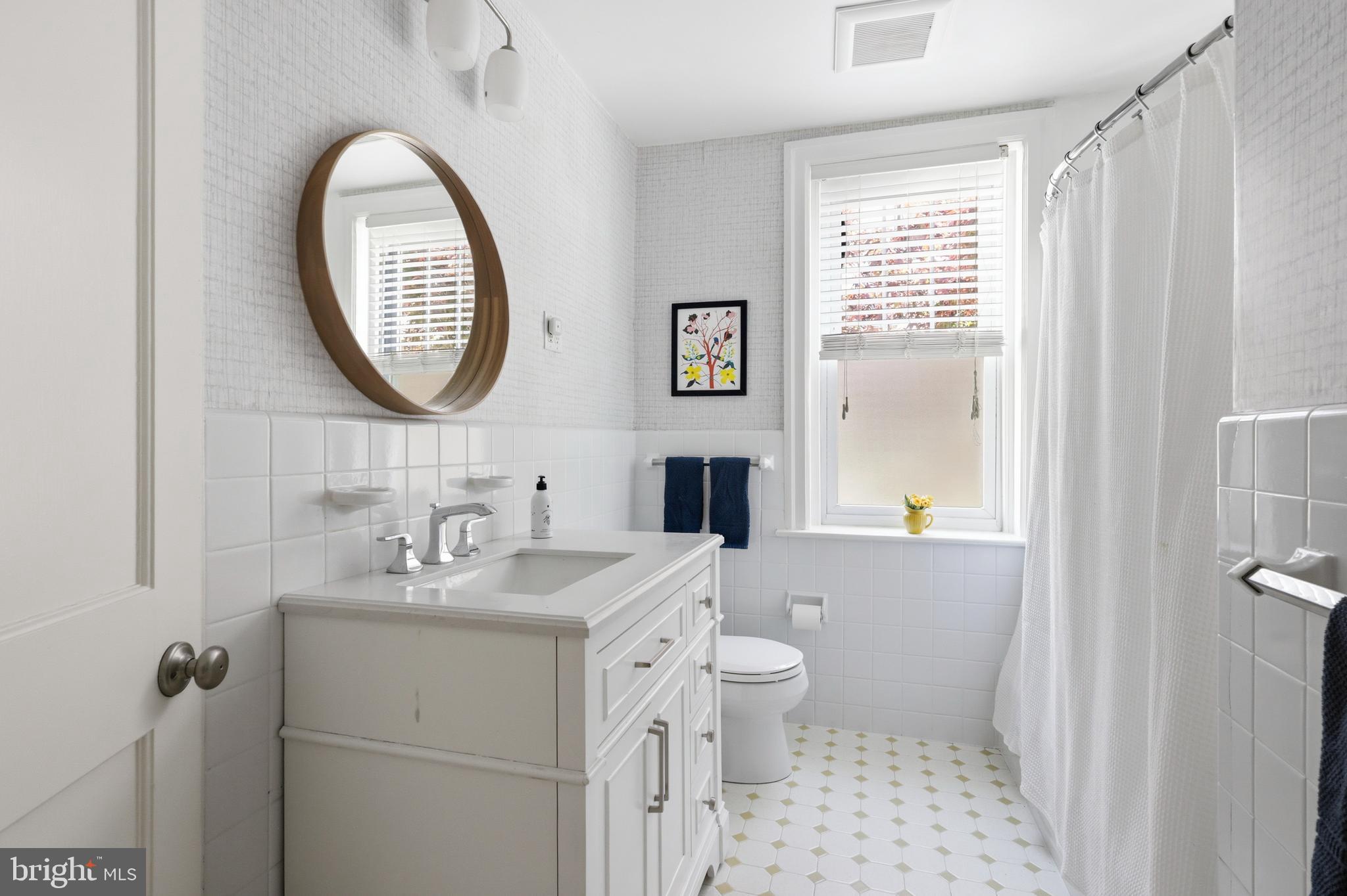 307 East Gravers Lane Philadelphia, PA 19118 - Photo 28 of 44 a bathroom with a toilet a sink and a mirror