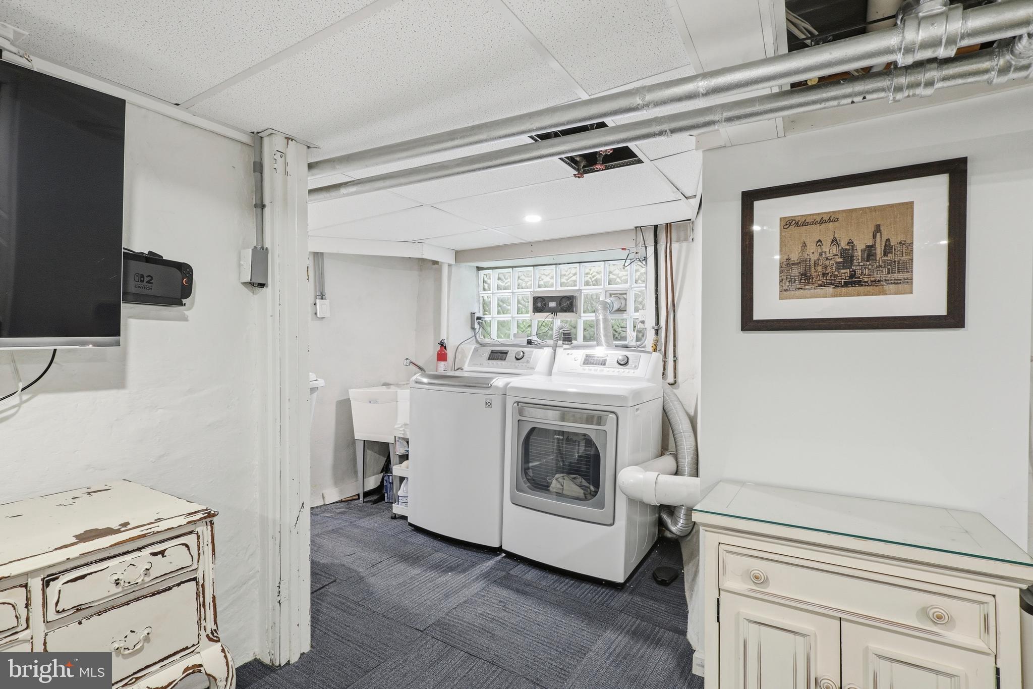 307 East Gravers Lane Philadelphia, PA 19118 - Photo 34 of 44 a utility room with cabinets washer and dryer