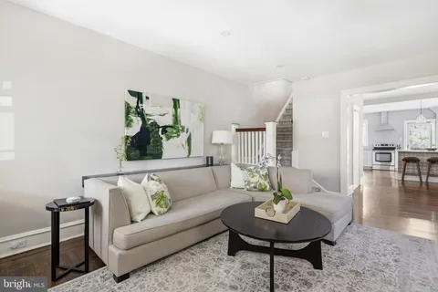 a living room with furniture and a table and chairs