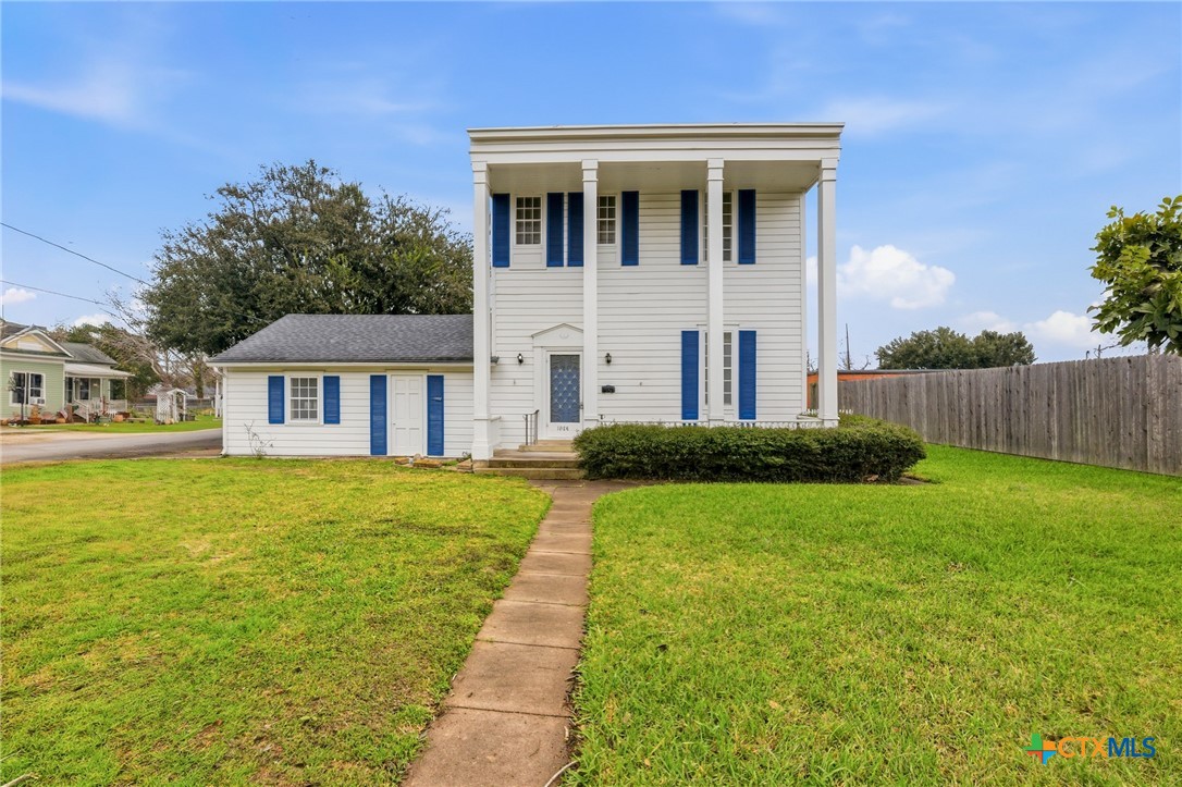 a front view of a house with a garden