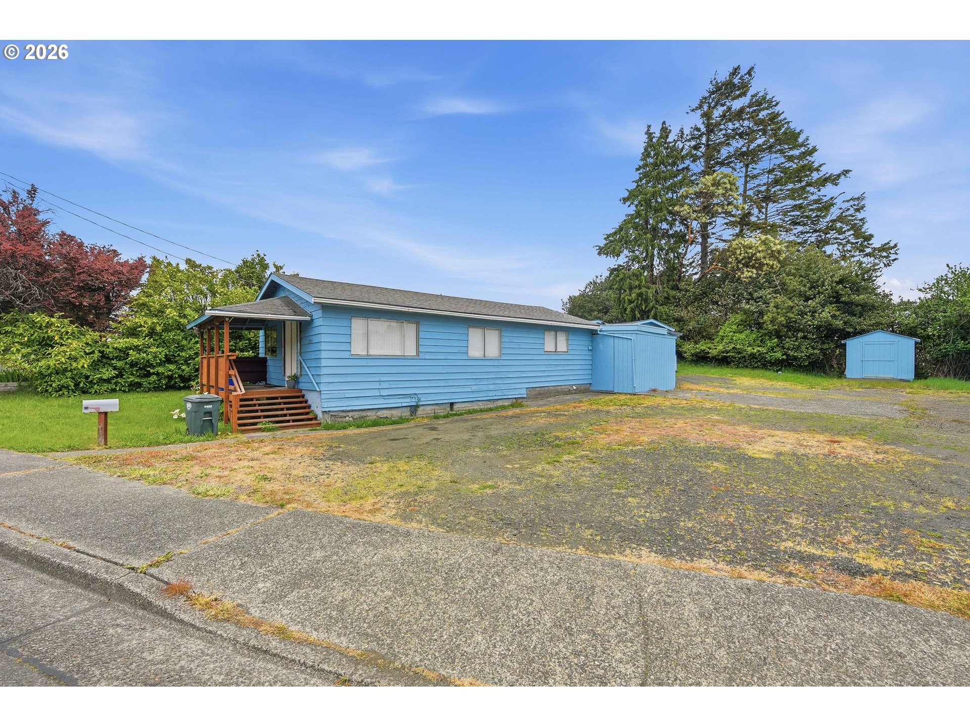 1955 Maple Street North Bend, OR 97459 - Photo 5 of 48 a front view of a house with a yard and a garage