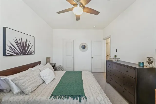 a bedroom with a large bed and a chandelier