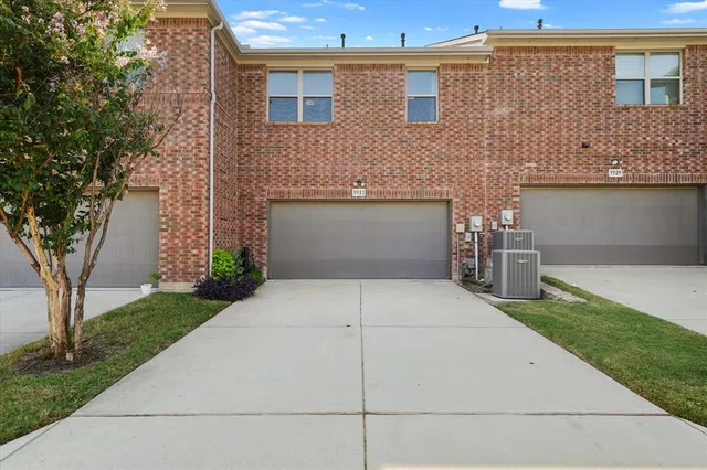 a front view of a house with a yard and a garage