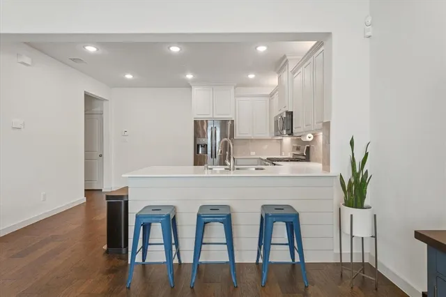 a kitchen with counter space dining table and chairs
