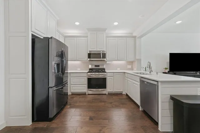 a kitchen with a refrigerator stove and oven