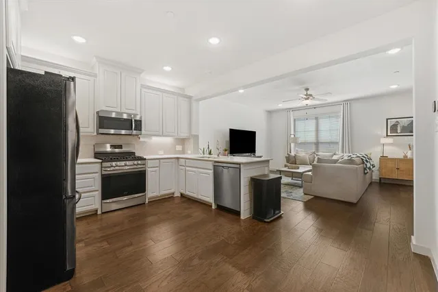 a kitchen with a refrigerator and a stove top oven