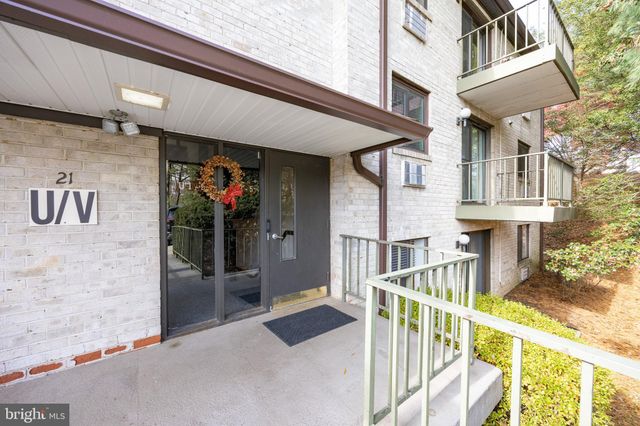 front view of house with large windows and wooden fence