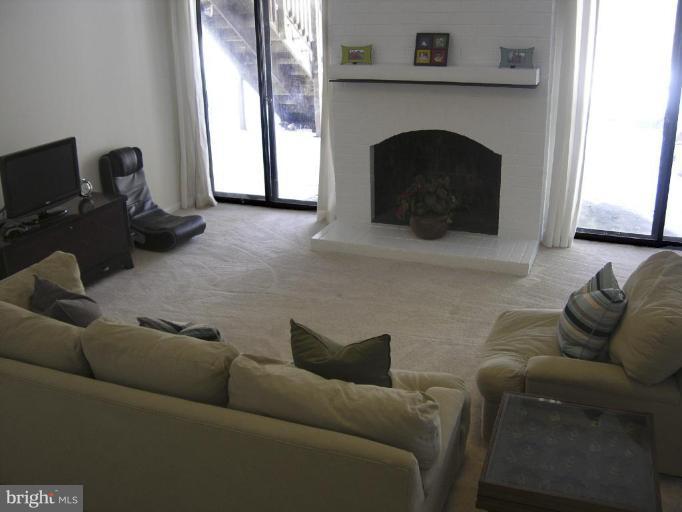 11820 Grey Birch Place Reston, VA 20191 - Photo 17 of 20 a living room with furniture and a fireplace