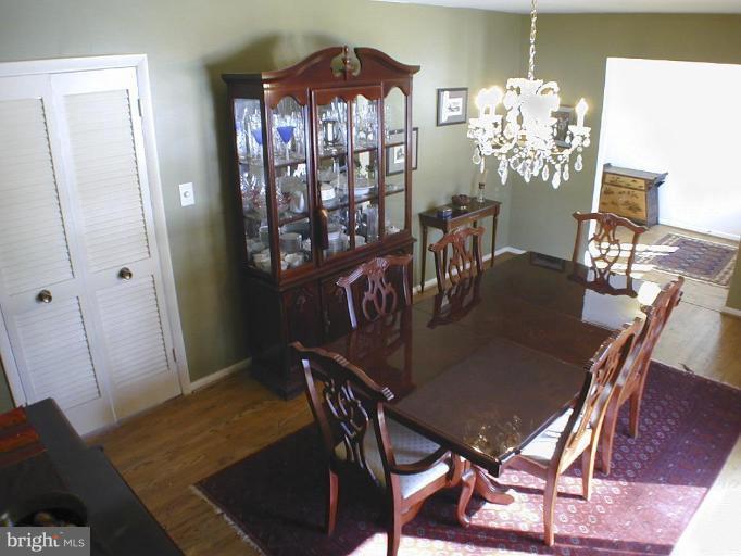 11820 Grey Birch Place Reston, VA 20191 - Photo 6 of 20 a view of a dining room with furniture and wooden floor