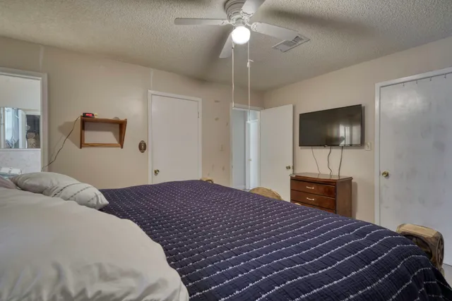 a bedroom with a bed and a flat screen tv