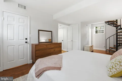 a bedroom with a bed and a flat tv screen