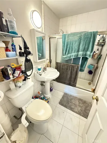 a bathroom with a toilet a sink and a mirror