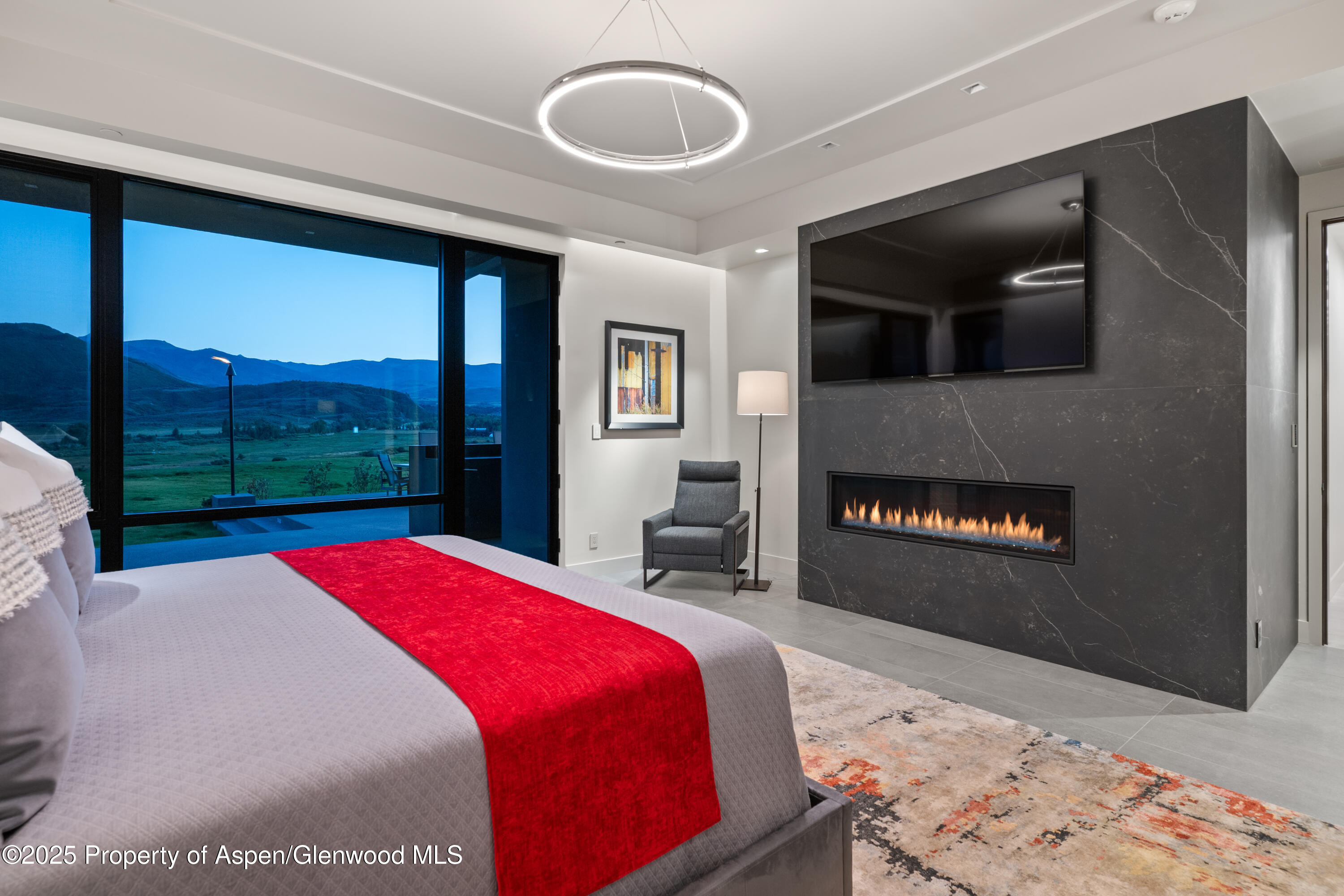 6890 East Sopris Creek Road Snowmass, CO 81654 - Photo 22 of 40 a bedroom with a bed and a large window