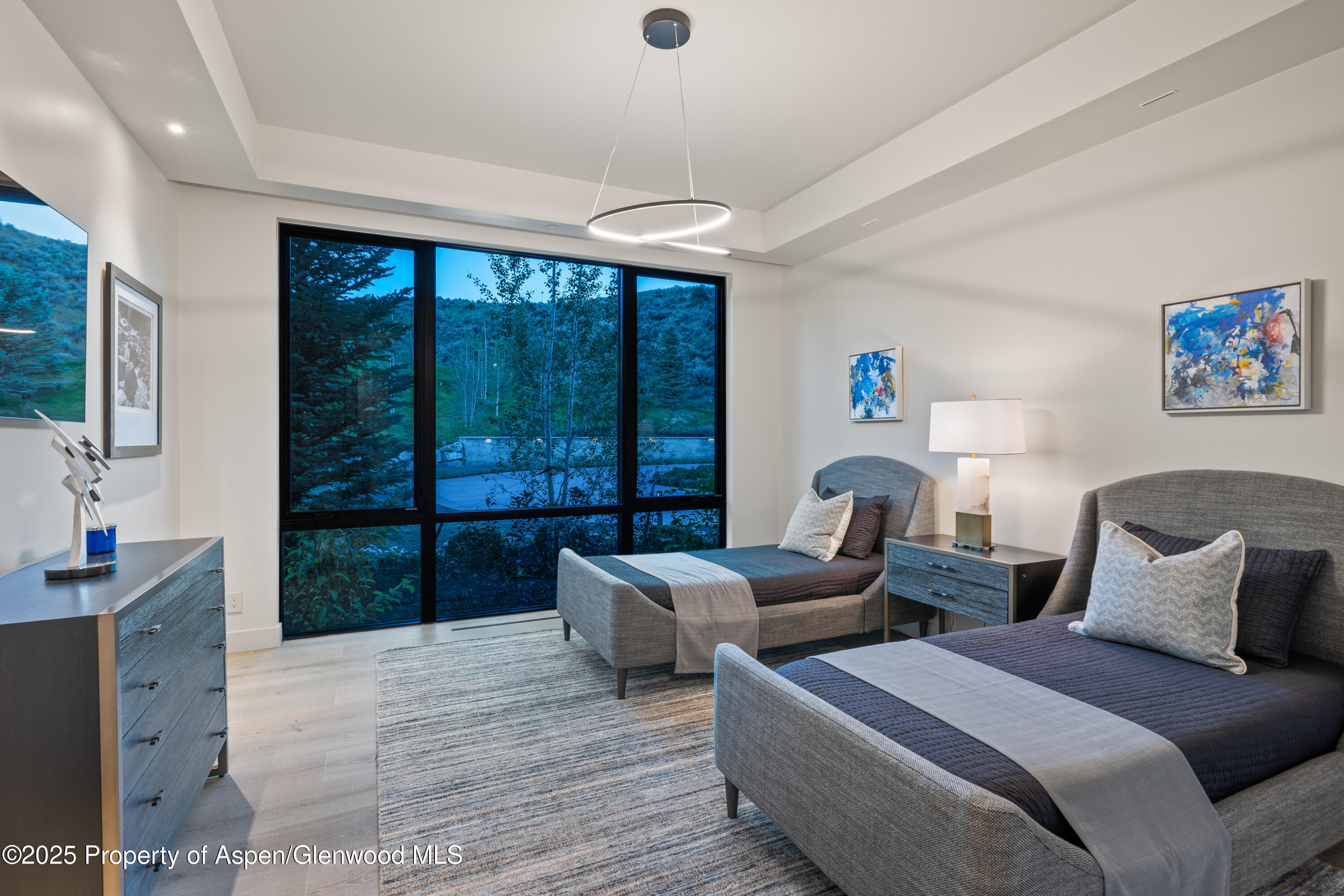 6890 East Sopris Creek Road Snowmass, CO 81654 - Photo 29 of 40 a bedroom with two beds and large window