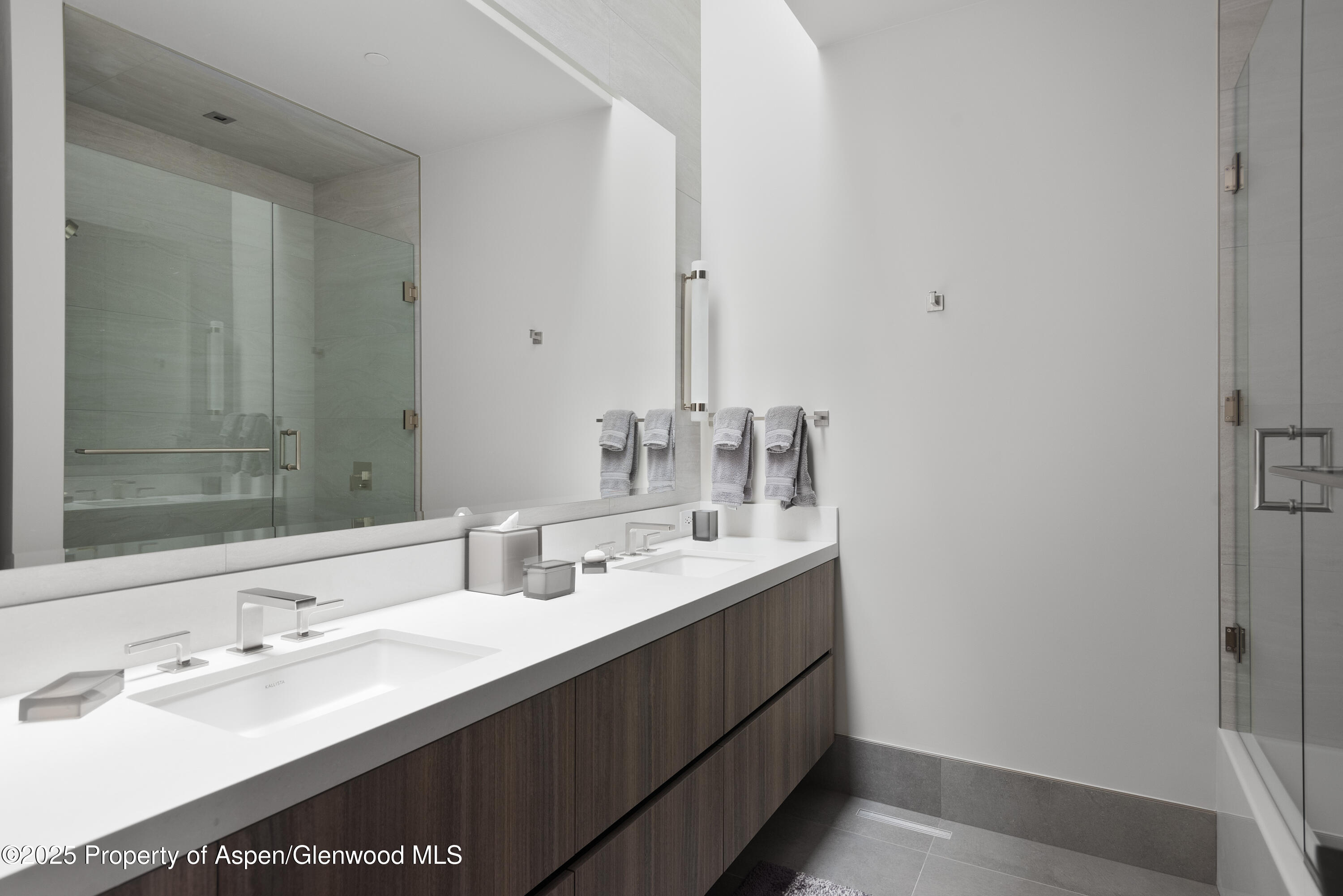 6890 East Sopris Creek Road Snowmass, CO 81654 - Photo 33 of 40 a bathroom with double vanity sink and a mirror
