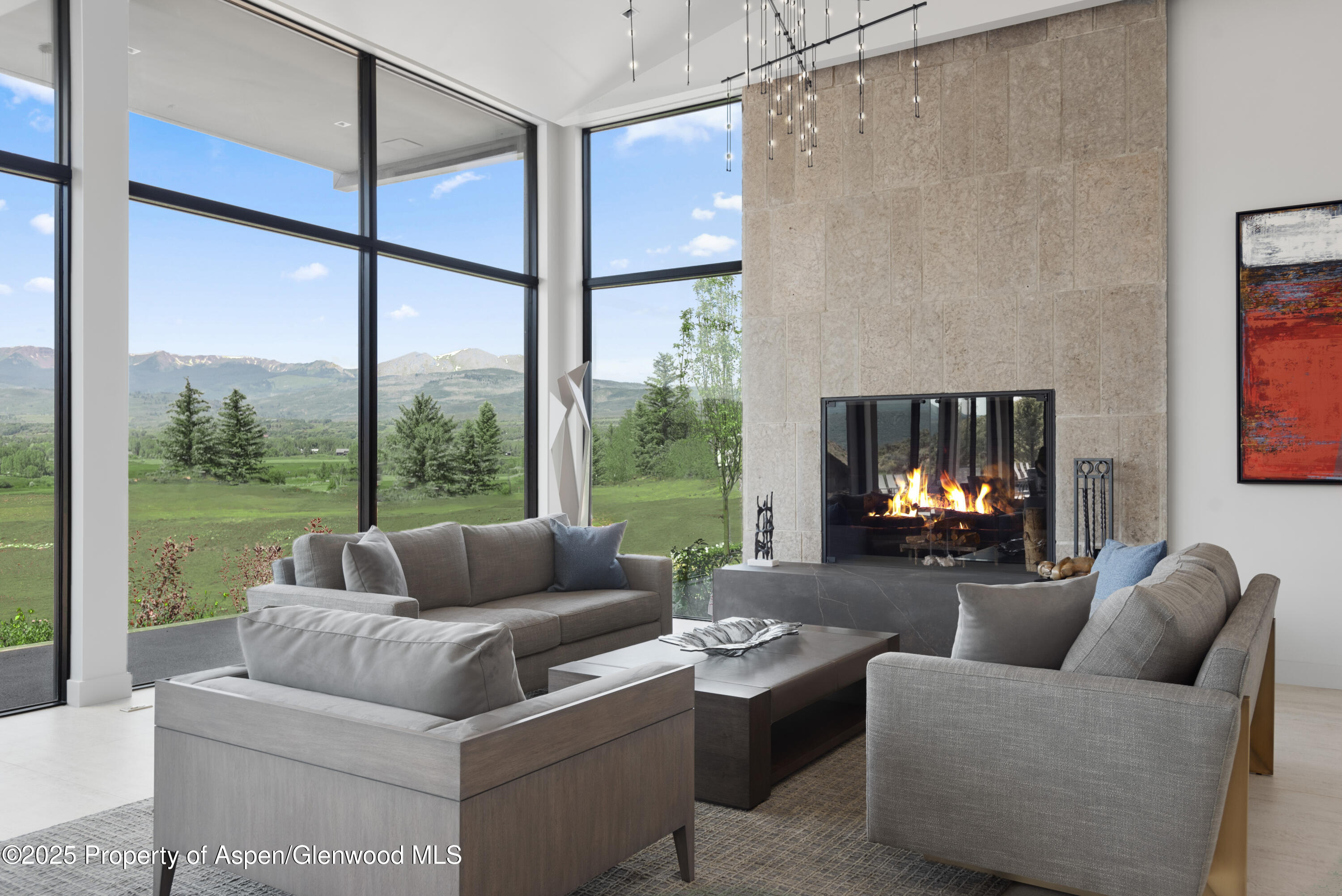 6890 East Sopris Creek Road Snowmass, CO 81654 - Photo 9 of 40 a living room with fireplace furniture and a large window