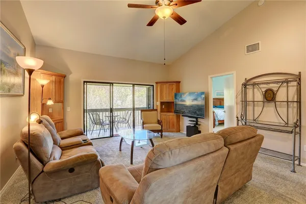 a living room with furniture and a floor to ceiling window