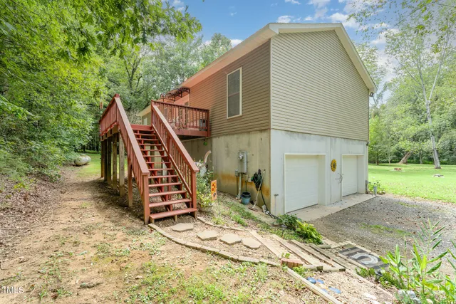 a view of backyard with a deck and wooden floor
