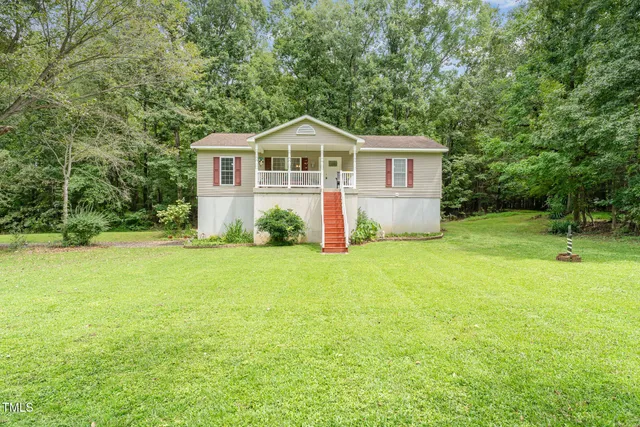 a house view with swimming pool in front of it